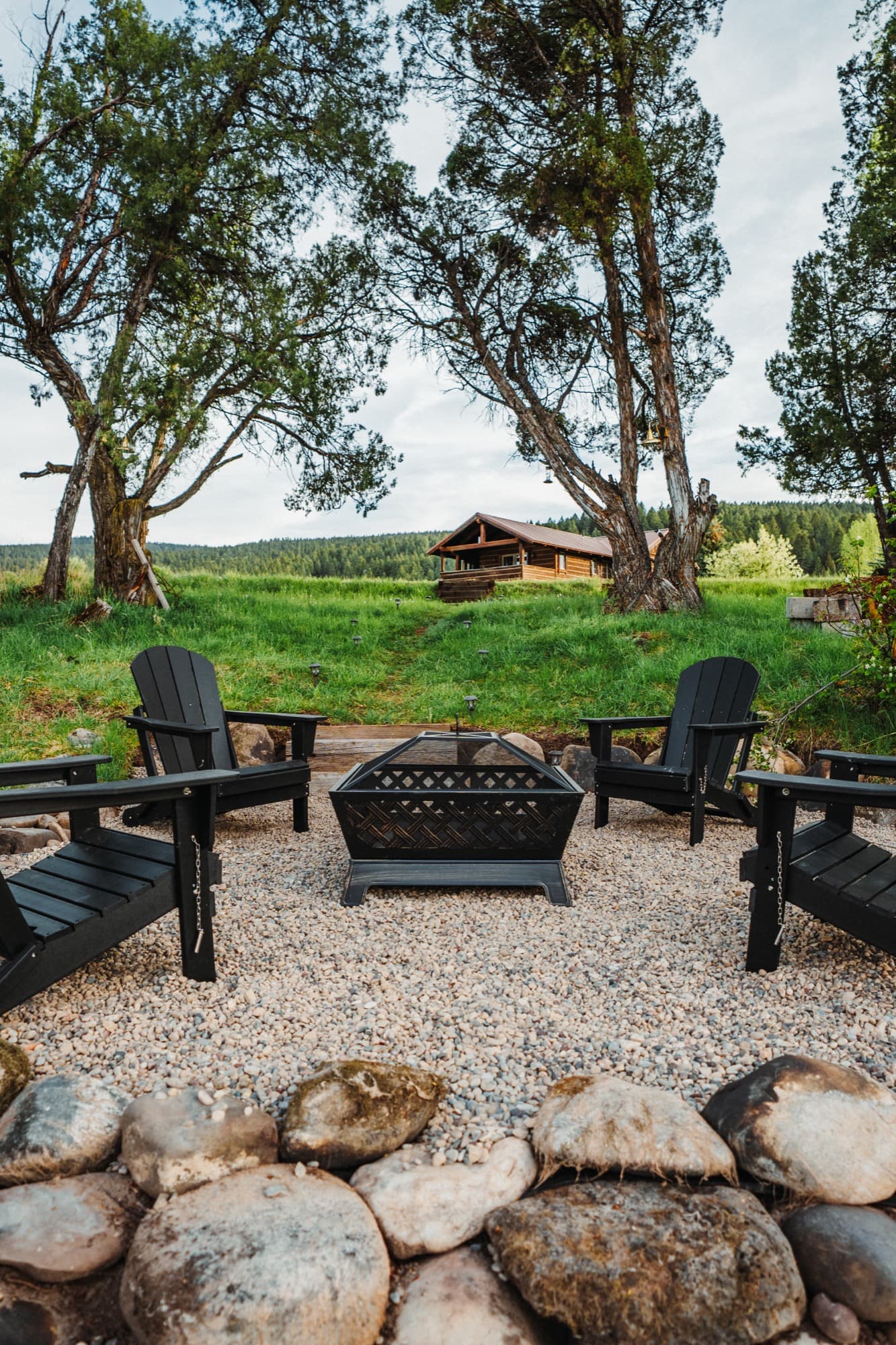 View from the riverside firepit up toward the log cabin